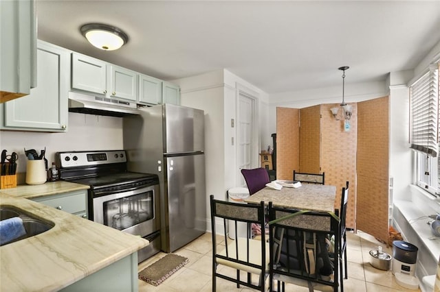 kitchen with appliances with stainless steel finishes, sink, pendant lighting, green cabinetry, and light tile patterned flooring