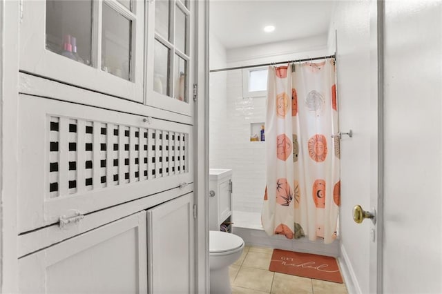 bathroom featuring toilet, tile patterned floors, and shower / bathtub combination with curtain