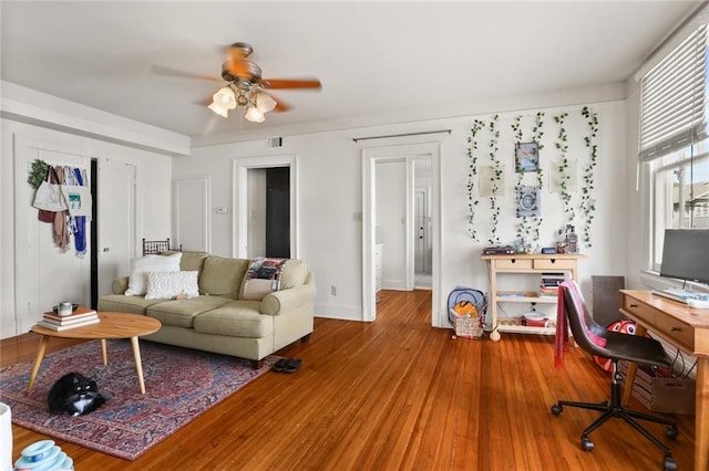 living room with wood-type flooring and ceiling fan