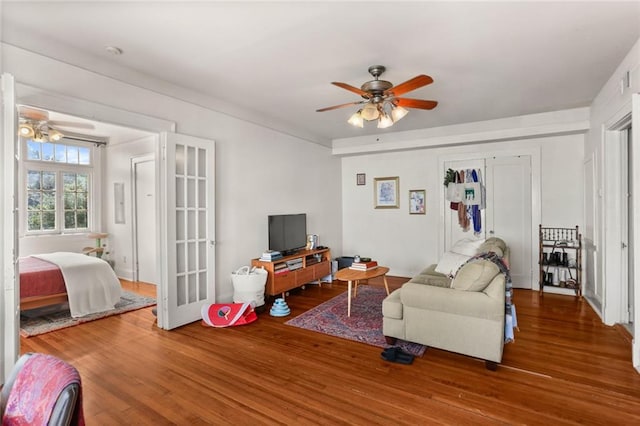 living room featuring ceiling fan and wood-type flooring