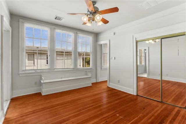 unfurnished bedroom with hardwood / wood-style flooring and ceiling fan