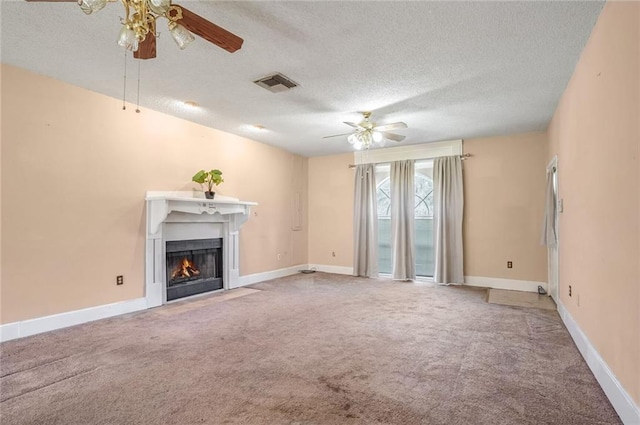69310 Jenkins Rd, Covington, LA 70433 - unfurnished living room featuring ceiling fan, a textured ceiling, a fireplace with flush hearth, carpet flooring, and baseboards