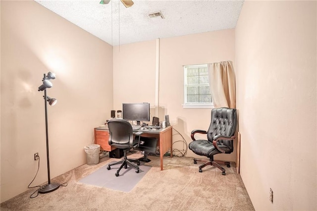 office featuring light carpet and a textured ceiling