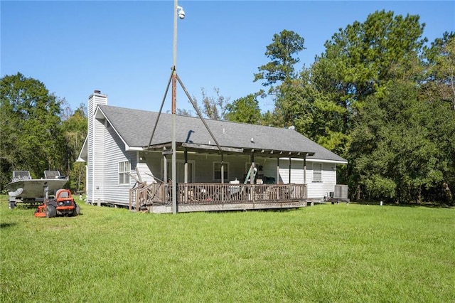 69310 Jenkins Rd, Covington, LA 70433 - back of property featuring a yard, a chimney, and a wooden deck
