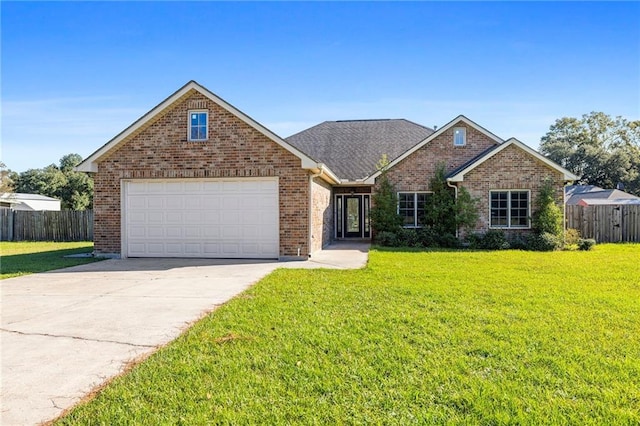 view of property with a front lawn and a garage