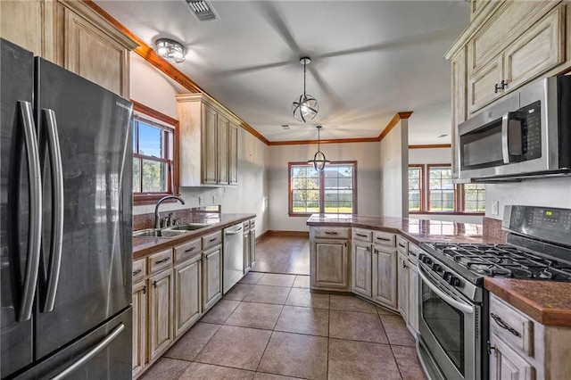 kitchen featuring ornamental molding, stainless steel appliances, sink, pendant lighting, and light tile patterned flooring