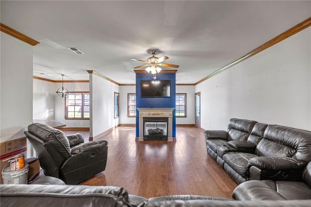 living room with hardwood / wood-style floors, ceiling fan, ornamental molding, and a wealth of natural light