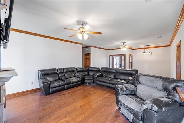 living room with hardwood / wood-style flooring, ceiling fan, and ornamental molding