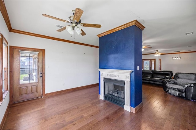 living room featuring ceiling fan, ornamental molding, and dark wood-type flooring