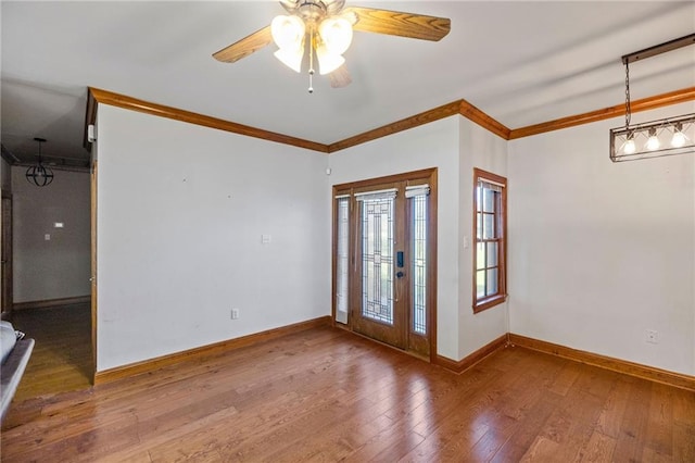 interior space with hardwood / wood-style floors, ceiling fan, and ornamental molding