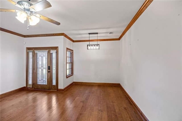 foyer entrance with hardwood / wood-style floors, ceiling fan, and crown molding