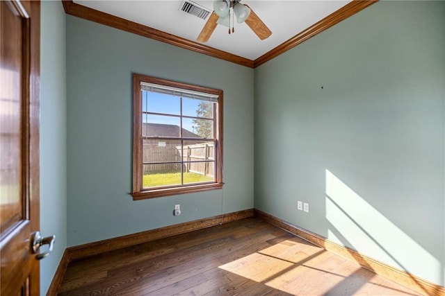 unfurnished room featuring ceiling fan, dark hardwood / wood-style floors, and ornamental molding