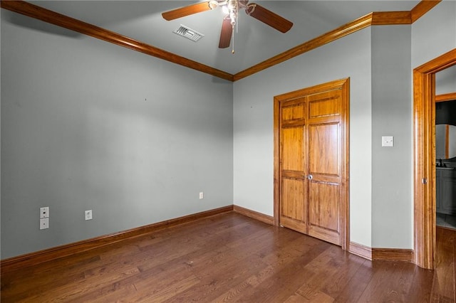 unfurnished bedroom with ceiling fan, dark hardwood / wood-style flooring, and ornamental molding