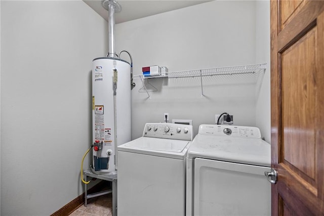 laundry area with gas water heater and independent washer and dryer