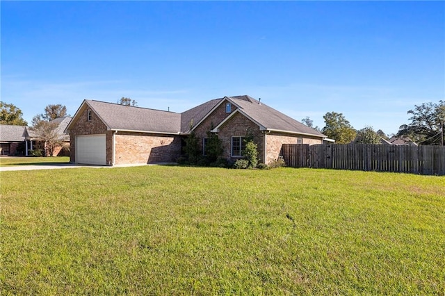 view of front of home with a front yard and a garage