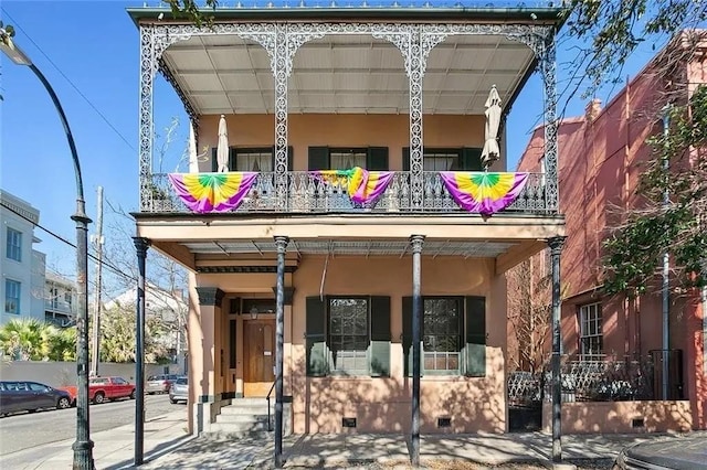 view of front of home with a balcony