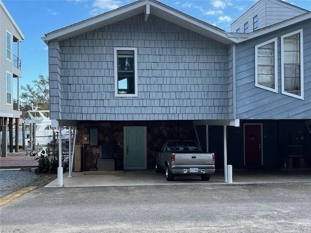 view of front of home featuring central AC unit and a carport