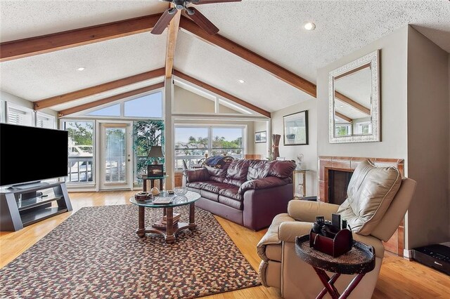 969 Marina Blvd Unit 969, Mandeville, LA 70471 - living area with plenty of natural light, lofted ceiling with beams, wood finished floors, and ceiling fan