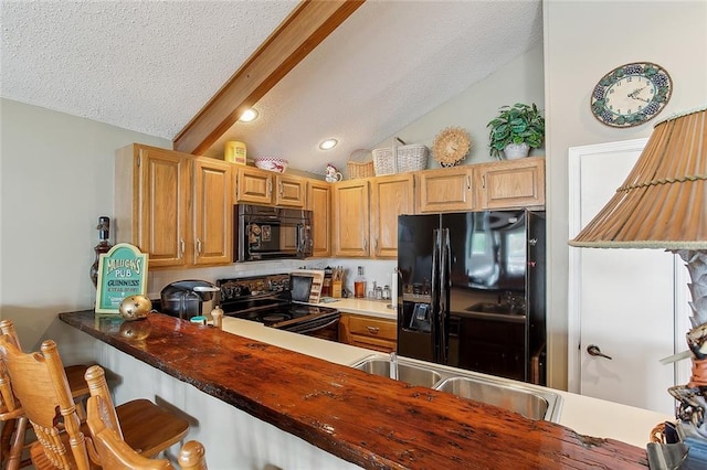 969 Marina Blvd Unit 969, Mandeville, LA 70471 - kitchen featuring a kitchen breakfast bar, lofted ceiling with beams, black appliances, and a textured ceiling
