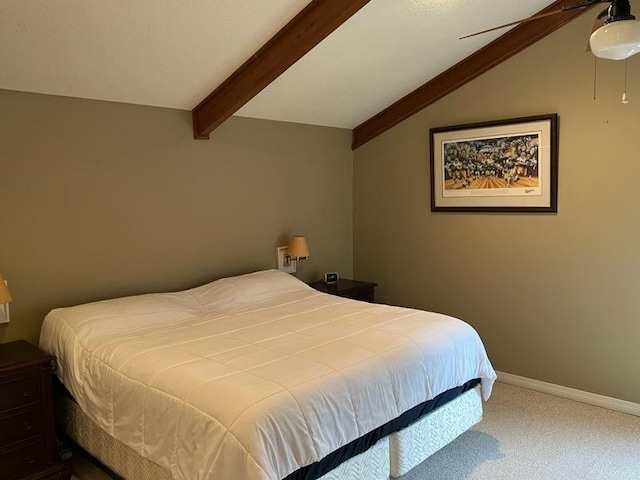 carpeted bedroom featuring lofted ceiling with beams