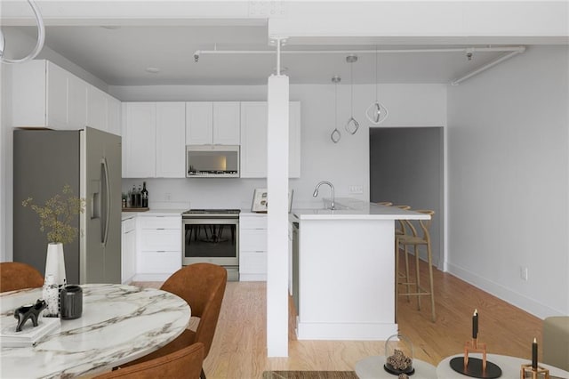 living area with visible vents, recessed lighting, and light wood finished floors