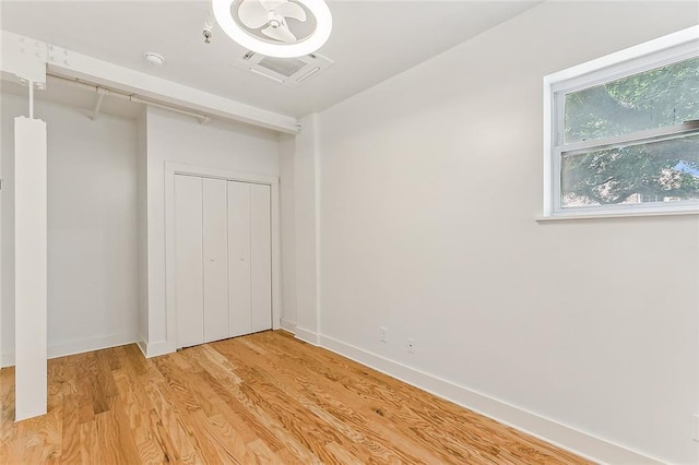 washroom with hookup for an electric dryer, light wood-type flooring, gas dryer hookup, baseboards, and laundry area
