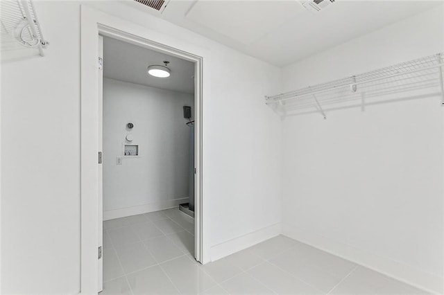 spacious closet featuring light tile patterned floors and visible vents