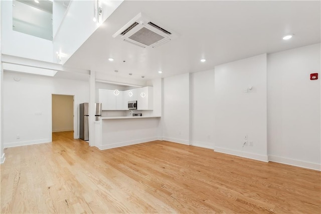 unfurnished living room with light hardwood / wood-style flooring