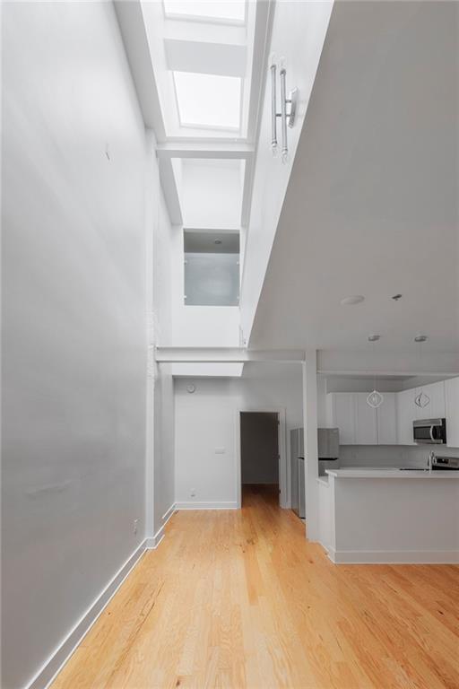 unfurnished living room featuring light wood-type flooring