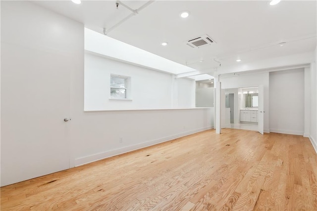 empty room with light hardwood / wood-style flooring