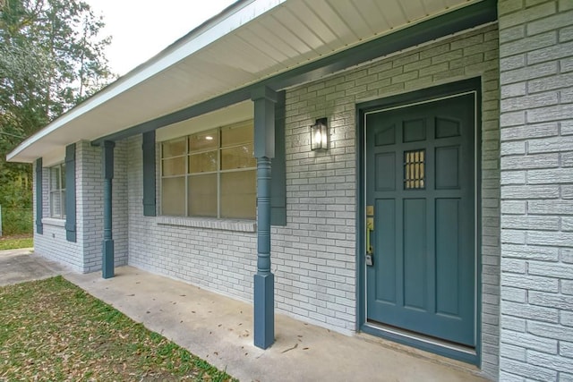 doorway to property featuring covered porch