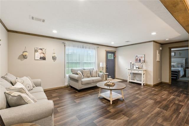 living room with dark hardwood / wood-style floors and ornamental molding