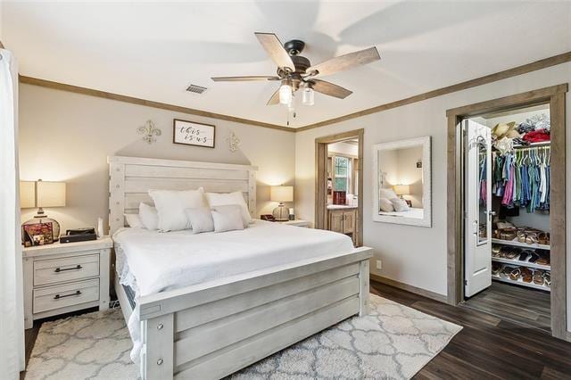 bedroom featuring ceiling fan, ornamental molding, dark wood-type flooring, and a closet