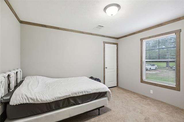 carpeted bedroom featuring ornamental molding