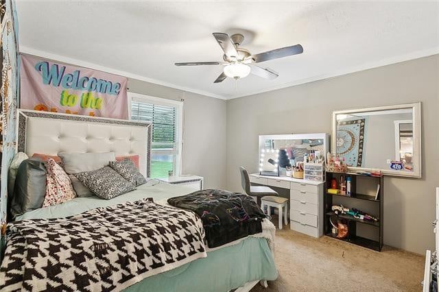 bedroom with light carpet, ceiling fan, and ornamental molding