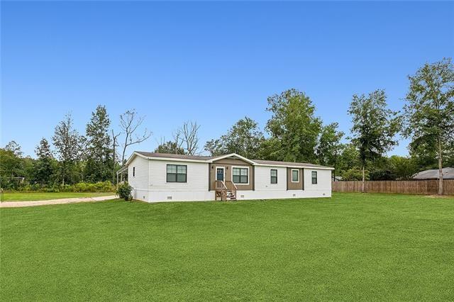 back of house with a yard