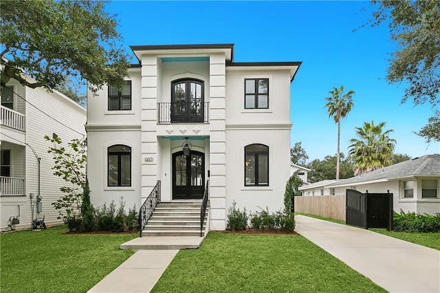 view of front of house featuring a front yard and french doors