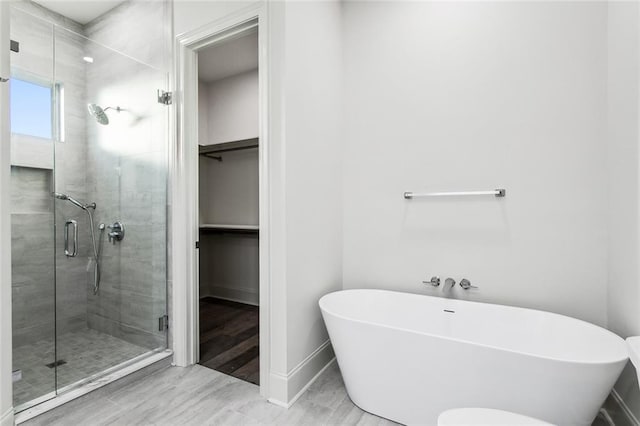 bathroom with shower with separate bathtub and hardwood / wood-style floors