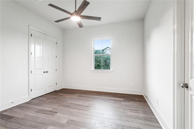 unfurnished bedroom featuring ceiling fan and light wood-type flooring