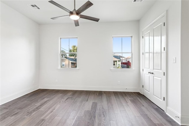 unfurnished room with hardwood / wood-style floors and ceiling fan