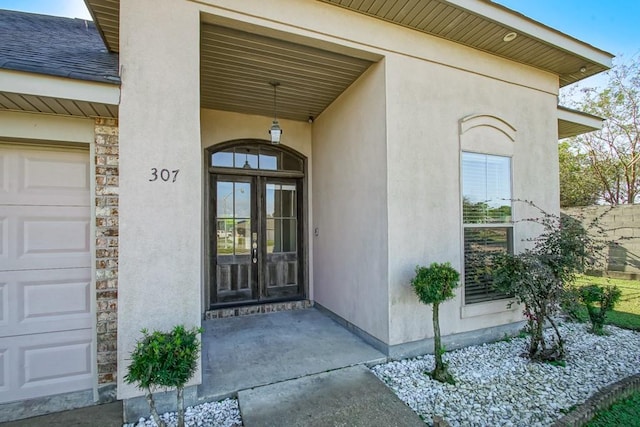 doorway to property with french doors and a garage