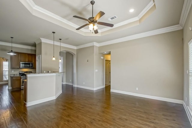 kitchen with crown molding, ceiling fan, appliances with stainless steel finishes, decorative light fixtures, and dark hardwood / wood-style flooring