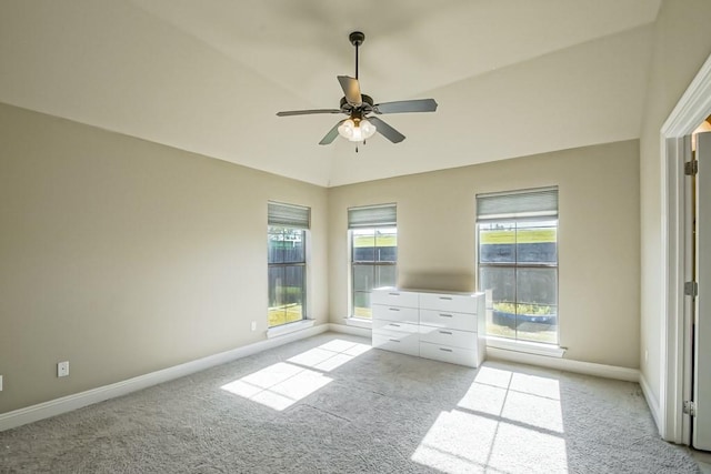 unfurnished bedroom with ceiling fan, light colored carpet, and vaulted ceiling