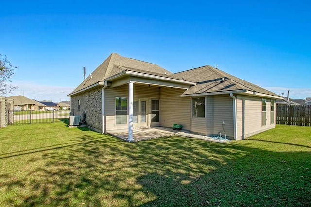 back of house with a yard, central AC unit, and a patio area