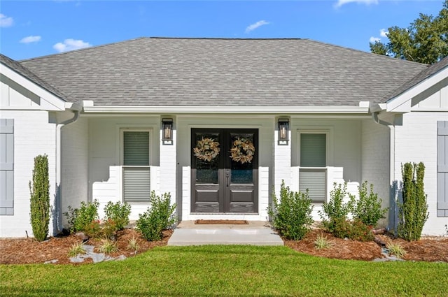 property entrance with a lawn and french doors