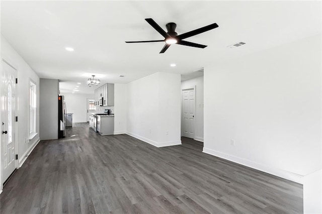 1917 Generes Dr, Harahan, LA 70123 - unfurnished living room featuring a chandelier, dark wood finished floors, recessed lighting, baseboards, and a ceiling fan