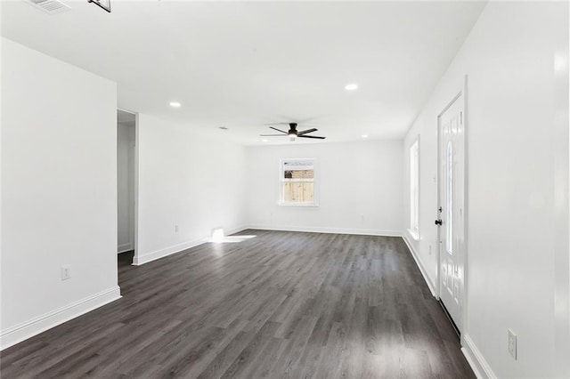 unfurnished living room with ceiling fan and dark wood-type flooring