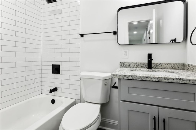 full bathroom featuring toilet, vanity, and tiled shower / bath combo