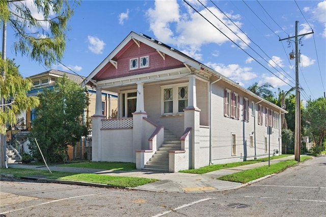 view of front facade with solar panels and a porch