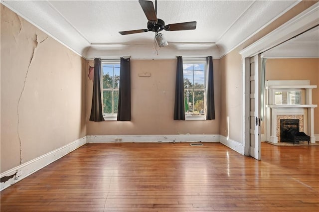 unfurnished room featuring light hardwood / wood-style floors, a wealth of natural light, and ceiling fan